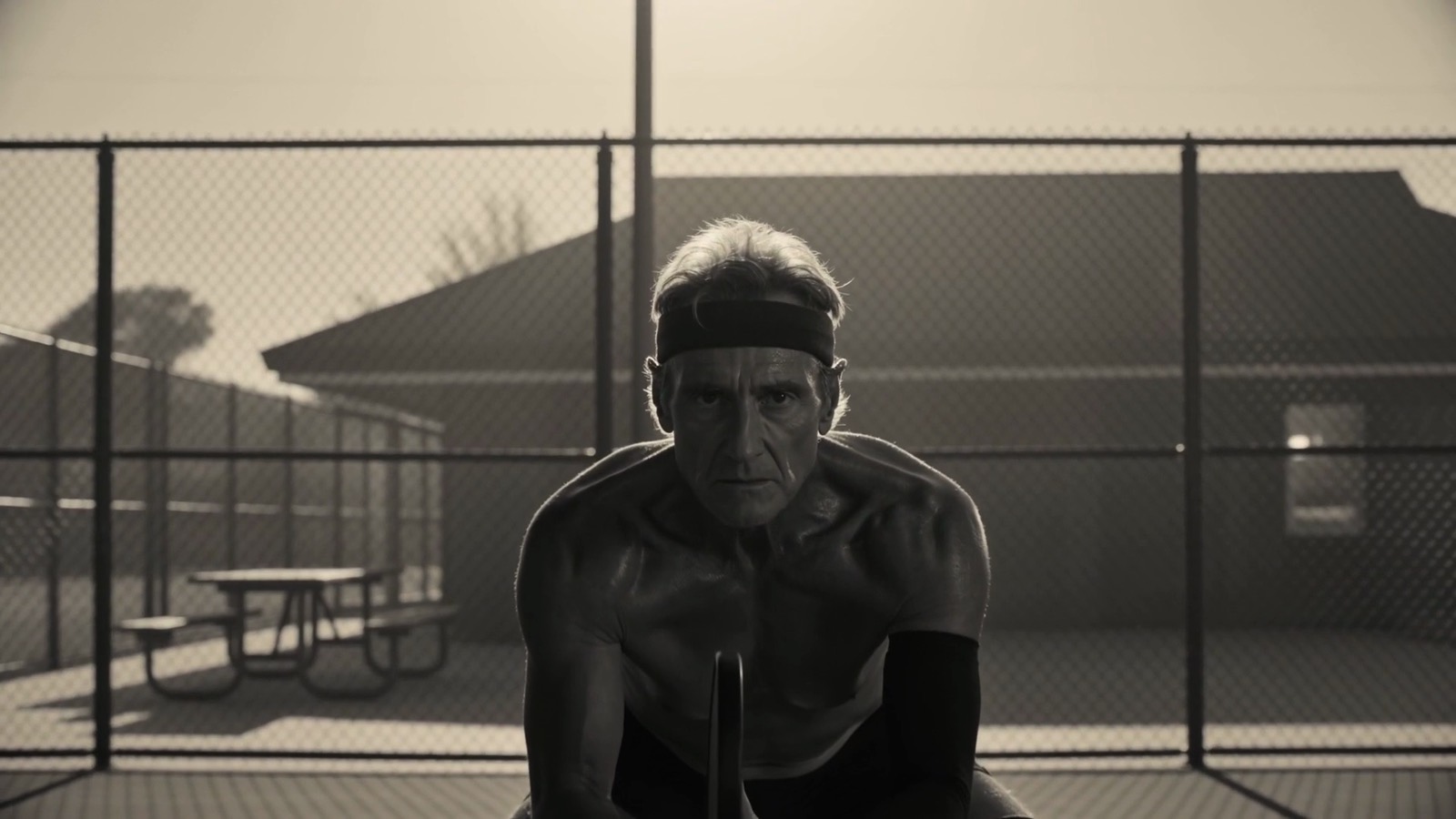 A man in a headband crouched in a ready stance at the kitchen line